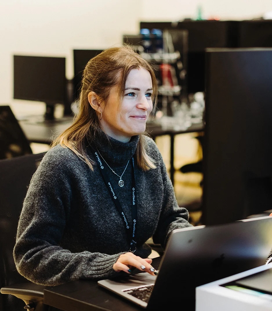 TestDevLab QA engineer working on AI-augmented software testing