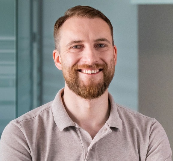 Portrait of a smiling man with a beard.