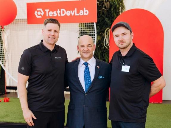 Company CEOs posing for a photo with U.S. Ambassador to Latvia, Christopher Robinson.