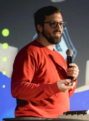 QA Engineer delivering a speech at a conference.