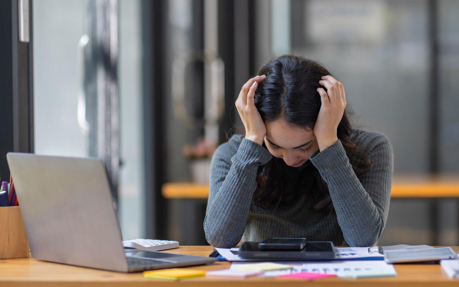 Overwhelmed woman at her desk