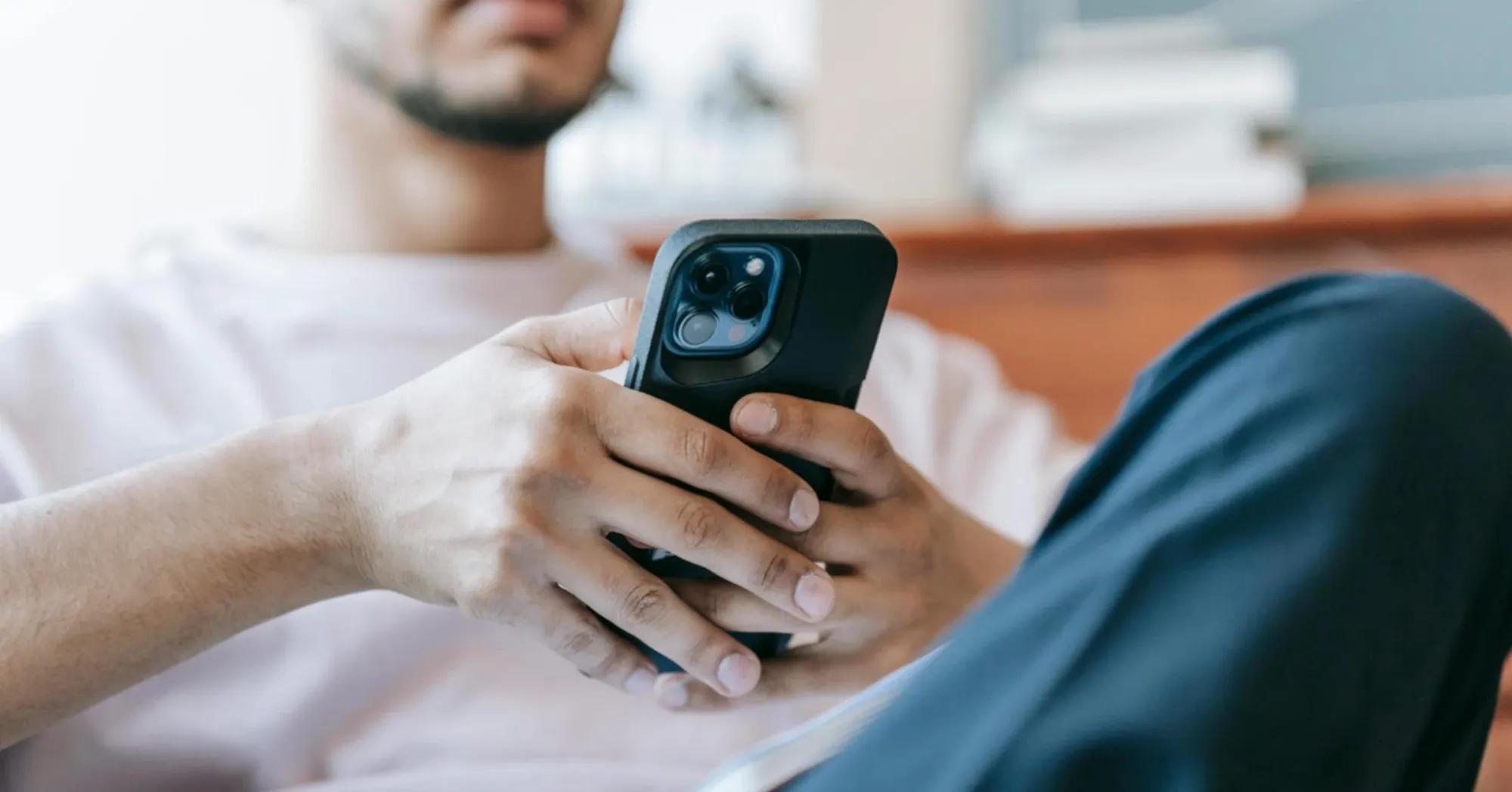 Person sitting down using mobile phone