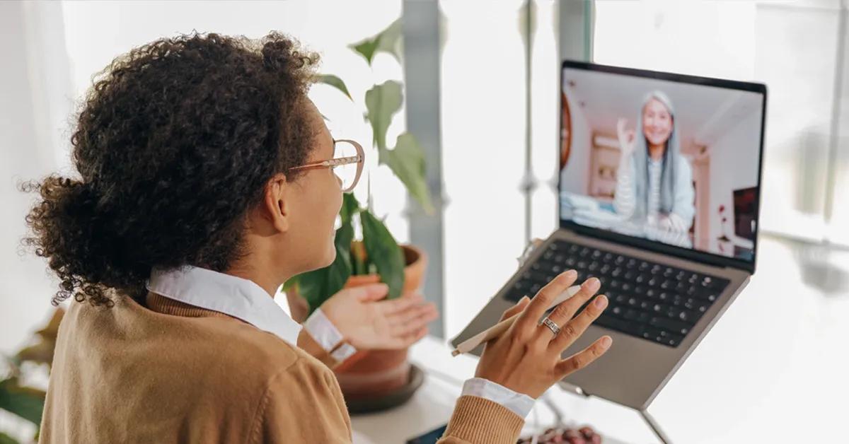 Woman using a laptop and chatting on a video call app 