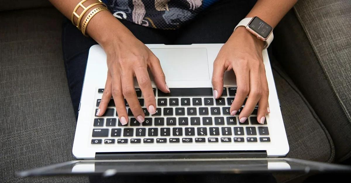 Woman typing on her laptop