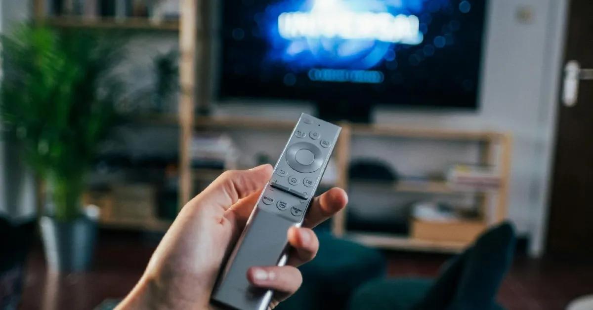 Person holding a remote for an Android TV