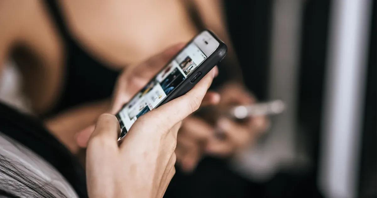 Woman looking at videos on her phone.