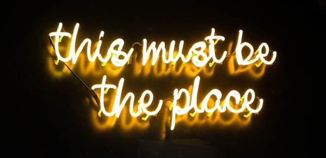 Neon sign reading “this must be the place”.