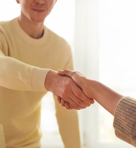 Two persons making a handshake. 