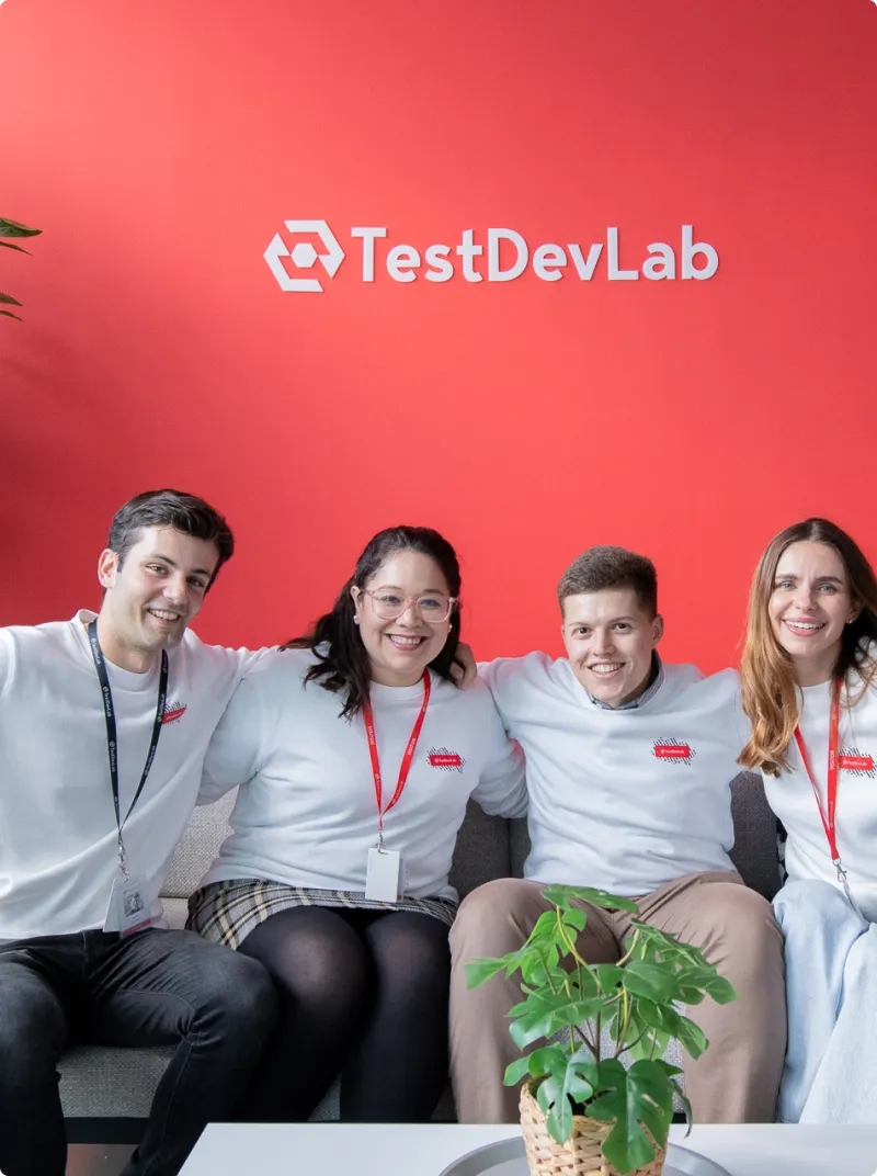 Four software engineers smiling.