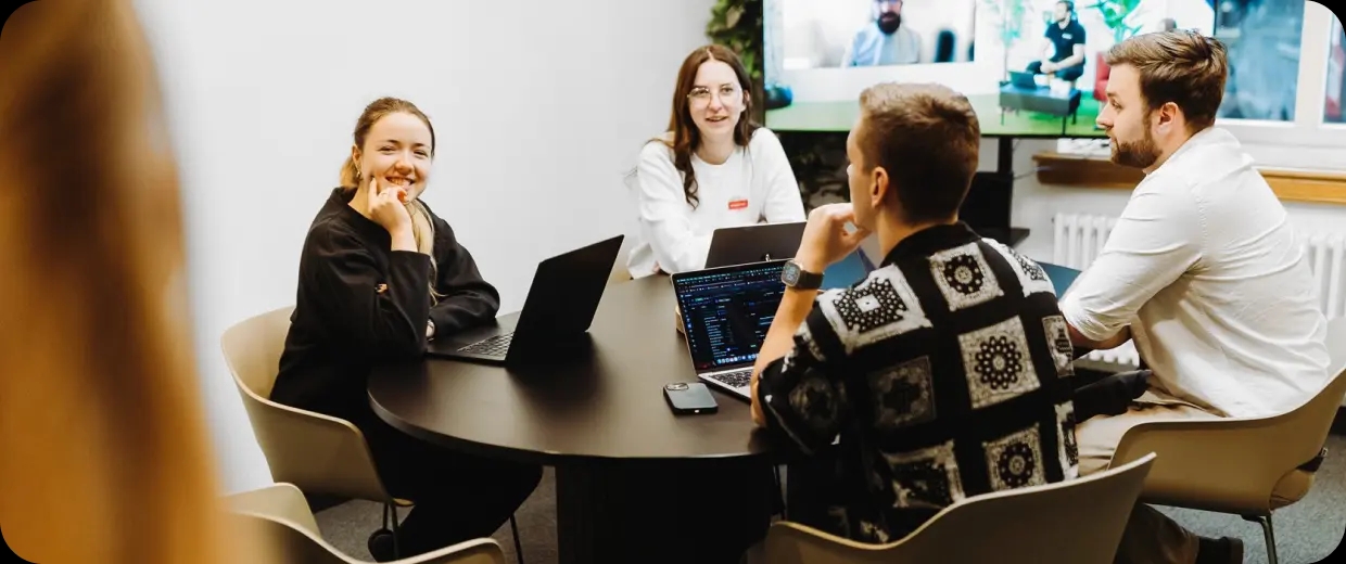 Three software engineers discussing project details.