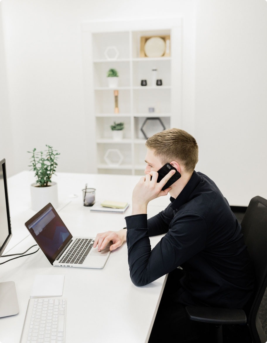 QA engineer testing communications solution on a mobile phone and laptop.