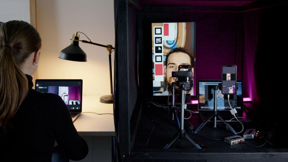 QA engineer performing audio and video quality testing in a standardized testing environment