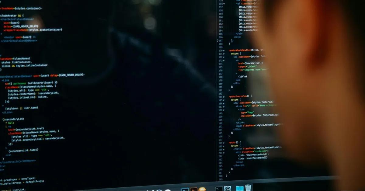 Man looks at codes on his computer screen
