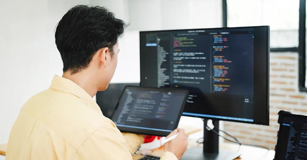 QA engineer performing automated tests on various devices