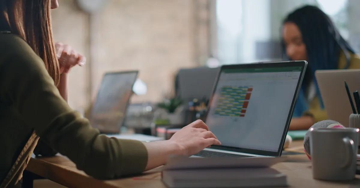 Woman sitting at desk working on laptop