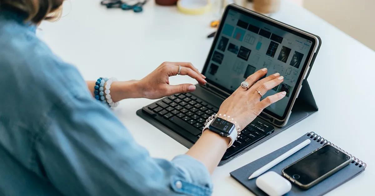 Woman sitting at desk working on laptop computer