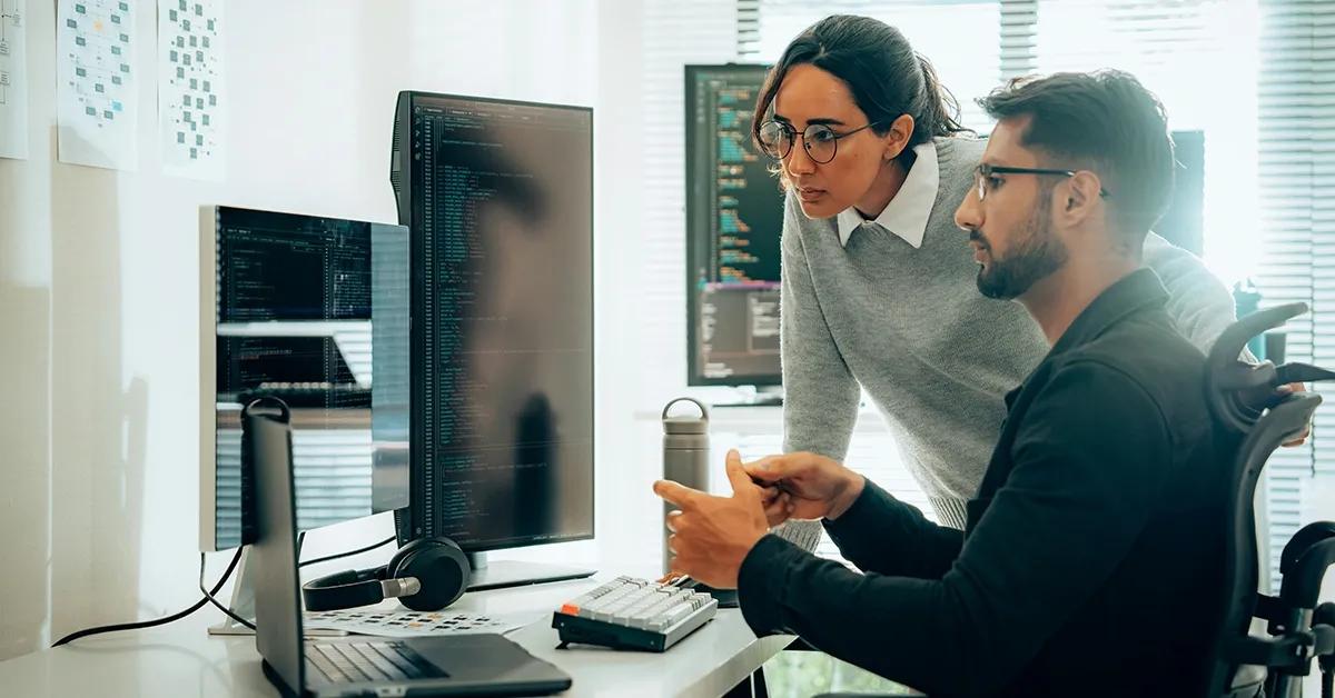 Team members working on a computer