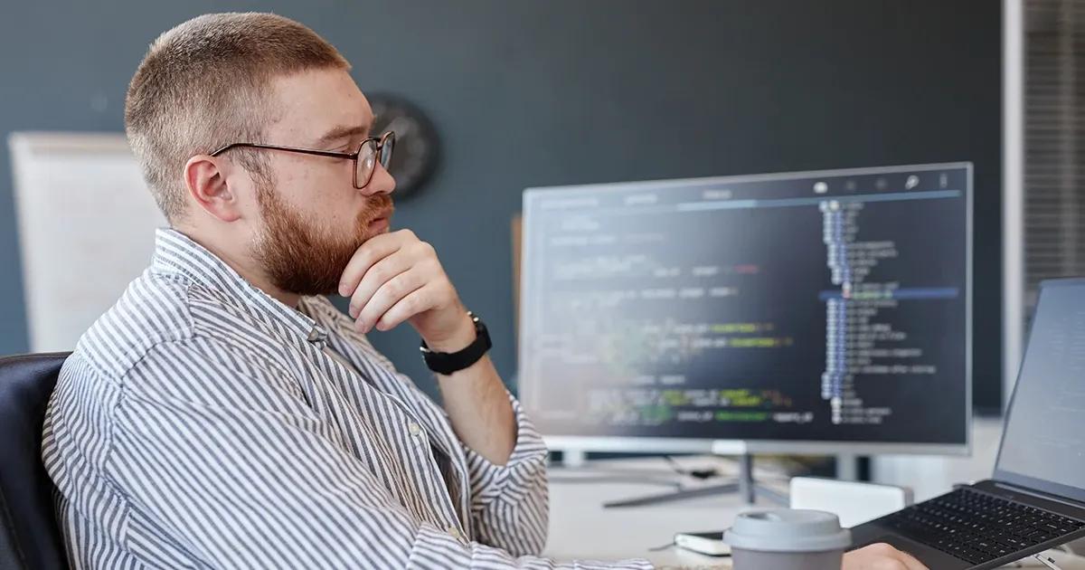 Man reviewing code on his computer.