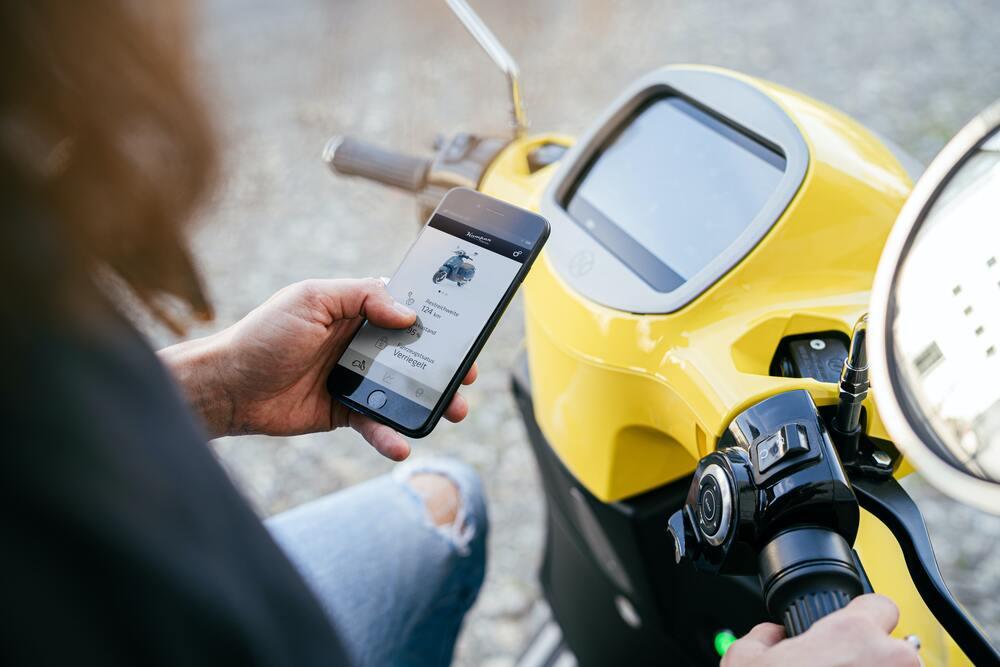 Person using a mobile app that is connected to a micromobility vehicle